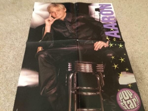 Aaron Carter leather pants and leather shirty bar stool. passes away poster