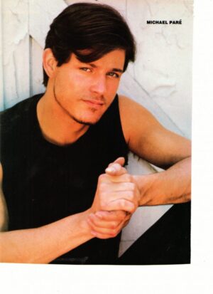 Michael Pare clasping hands muscles