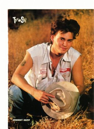 Johnny Depp squatting grass cowboy hat