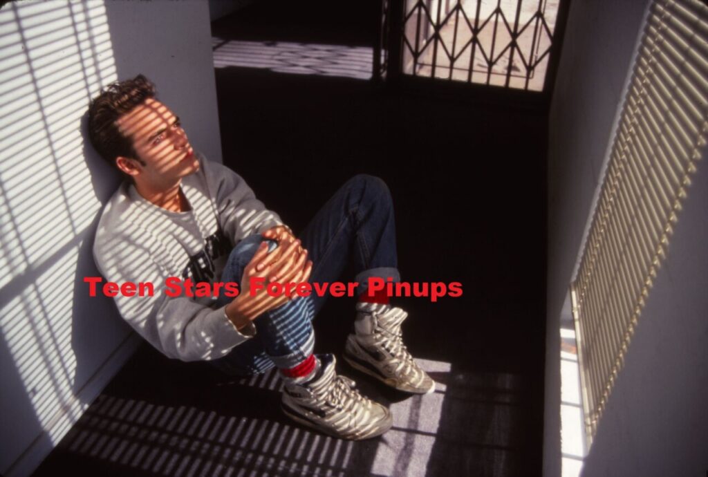 Luke Perry closet sitting down looking down Beverly Hills 90210 photo shoot