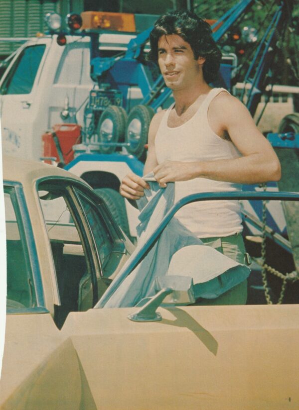 John Travolta muscles in a car