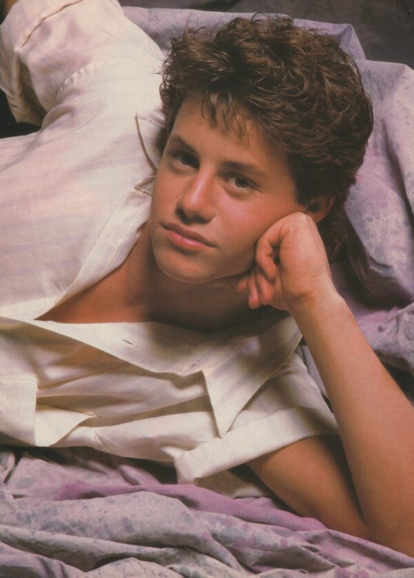 Growing Pains Kirk Cameron laying white dress shirt sheets photo shoot Teen Beat celebrity