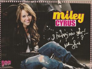 Miley Cyrus teen magazine pinup clipping Disney Star ripped jeans black boots